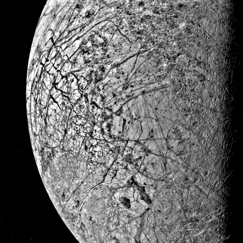 Image 1.8: Global view of Europa showing the fractured ice surface with brown-red lineae crisscrossing the bright white ice shell.